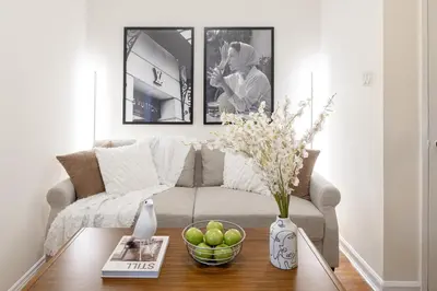 a living room with a couch and a table at Cozy 1BD Upper East Side Gem in New York