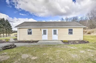 a small yellow house in a field at Quadruple Suites At Equestrian House in Pleasant Mount