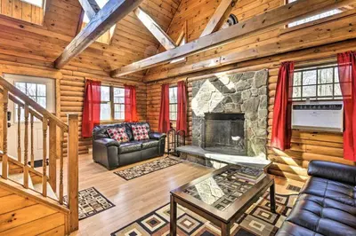 a living room with a fireplace in a log cabin at Wander & Unwind, Log Cabin and Suites Close to Ski Mountain in Pleasant Mount