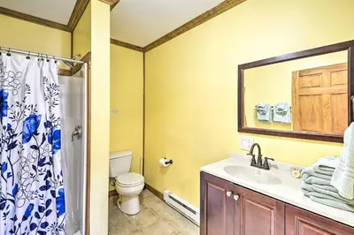 a bathroom with a sink and a toilet and a mirror at Family Suites Close to Elk Mountain Ski Resort in Pleasant Mount