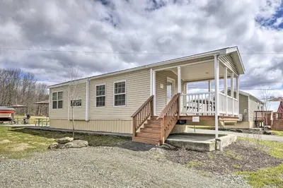a small house with a porch and stairs on it at Tranquil Trails Cabin & Suites Near Ski Area in Pleasant Mount