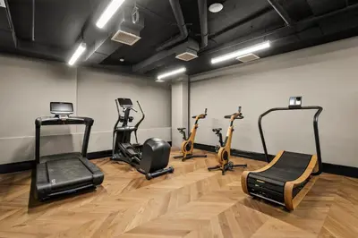 a gym with treadmills and exercise bikes in a room at Freeman 701 by Rove Travel - Studio with Shared Amenities in New York