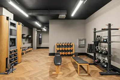 a room with a gym with dumbbells on the wall at Freeman 403 by Rove Travel - 1BR Condo with Shared Amenities in New York