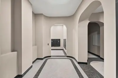 a hallway of a building with white walls and a carpet at Freeman 803 by Rove Travel - 1BR Condo with Shared Amenities in New York
