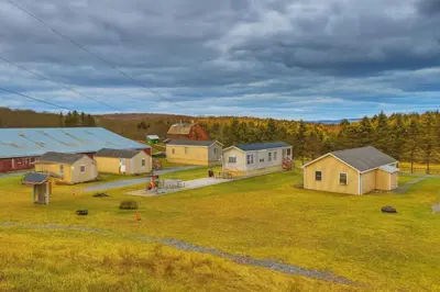 an aerial view of a farm with houses and trees at Cottage and Suite Close to Camps and Ski Resorts in Pleasant Mount