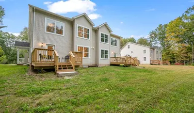 a house with two decks and a yard at Ideal Family Stay Sleeps 20 in Bloomfield, CT in Bloomfield
