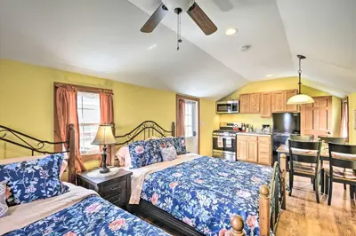 a bedroom with two beds and a kitchen at Deluxe Duplex close to Ski Runs in Pleasant Mount