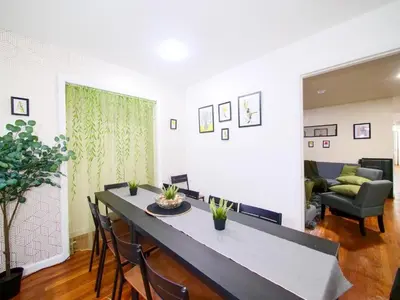 a living room with a table and chairs and a couch at Charming Private Room in a Friendly Home mins to NYC in Jersey City