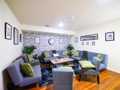 a living room with blue couches and a table at Cozy Private Room with Shared Kitchen near NYC in Jersey City