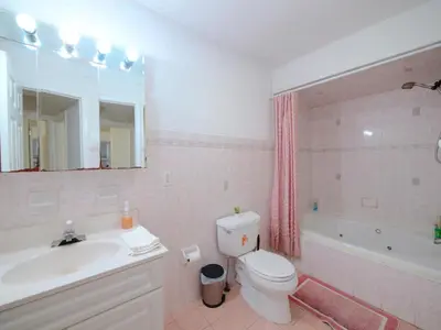 a bathroom with a sink and a toilet and a tub at Cozy Private Room with Shared Kitchen near NYC in Jersey City