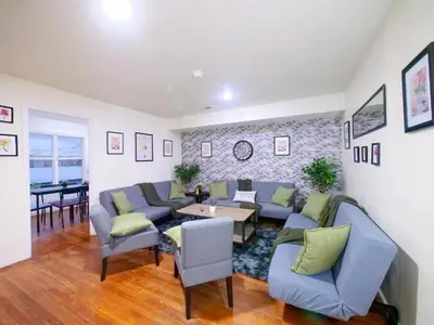 a living room with blue couches and a table at Private Bedroom with Shared Amenities mins to NYC in Jersey City