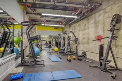 a gym with a bunch of equipment in a room at Blueground Williamsburg rooftop nr East River NYC-1942 in Brooklyn