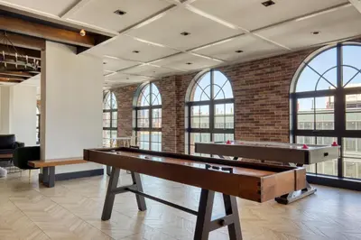 a pool table in a room with windows at Blueground Williamsburg rooftop nr East River NYC-1942 in Brooklyn