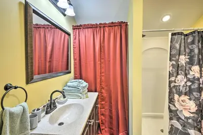 a bathroom with a sink and a red shower curtain at Suite to Unwind Close to Skiing in Pleasant Mount