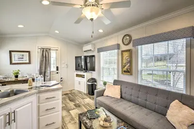 a living room with a couch and a kitchen at Cottages and Suites near Ski Slopes in Pleasant Mount