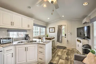 a kitchen with white cabinets and a sink at Cottages and Suites near Ski Slopes in Pleasant Mount