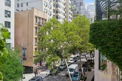a city street with cars parked on the street at Sweet and Cozy 1 Bedroom Apt in Lenox Hill in New York