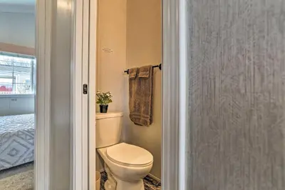 a bathroom with a toilet and a towel at Log Cabin And Cottages At Equestrian House in Pleasant Mount