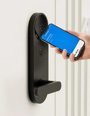 a person holding a cell phone in front of a door at 22nd Sleek Modern 1BR Gramercy in New York