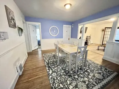a dining room with a table and chairs on a rug at NightShiftReady Binghamton Trades Nurses Welcome Private Room in Shared Apartment in Binghamton