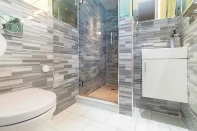 a bathroom with a toilet and a shower at New2 York Stylish 2BR Apartment in Manhattan in New York