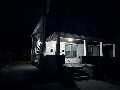 a house with a light on the front of it at night at Nona - Private Room 3 with Parking, Desk & Fast WiFi near Yale, Quinnipiac, SCSU & Hospitals in Hamden