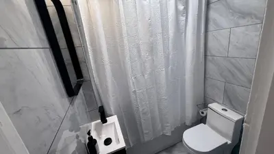 a bathroom with a white shower curtain and a toilet at Nona - Private Room 3 with Parking, Desk & Fast WiFi near Yale, Quinnipiac, SCSU & Hospitals in Hamden