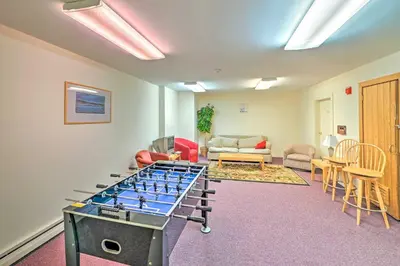 a room with a ping pong table in the middle at Walk to Mt Snow Ski Shuttle! Condo with Resort Perks in West Dover