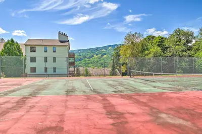 a tennis court in front of a house at Walk to Mt Snow Ski Shuttle! Condo with Resort Perks in West Dover