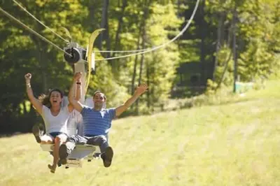 a man and woman are riding on a swing at Mountain Getaway Suite Ski OnOff Jiminy Peak - Fully Redone Decor in Hancock