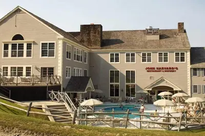 a large building with a swimming pool in front of it at Mountain Getaway Suite Ski OnOff Jiminy Peak - Fully Redone Decor in Hancock