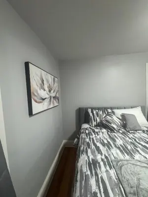 a bedroom with a bed with a picture on the wall at Newly Renovated Single Family Home in Springfield