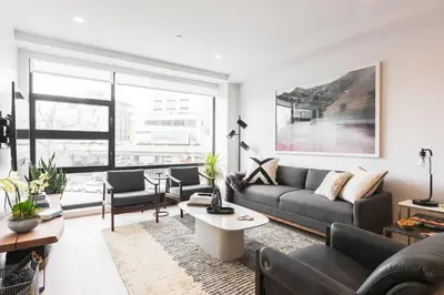 a living room with a couch and a table at Union Residence by Rove - Gorgeous Williamsburg Condo in Brooklyn