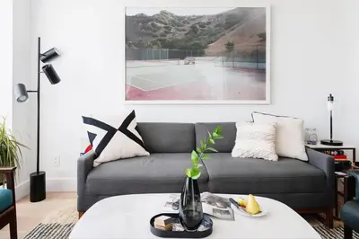 a living room with a couch and a tennis court at Union Residence by Rove - Gorgeous Williamsburg Condo in Brooklyn