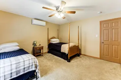 a bedroom with two beds and a ceiling fan at Mount Vision Home for Cooperstown Baseball Fams in Mount Vision