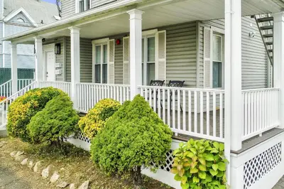 a white house with bushes on the front porch at Harbor Haven, Apt # 3, 3BR/2BA in Stamford