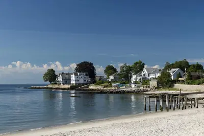 a group of houses on a beach next to the water at Harbor Haven, Apt #4 - 2BR/1BA in Stamford