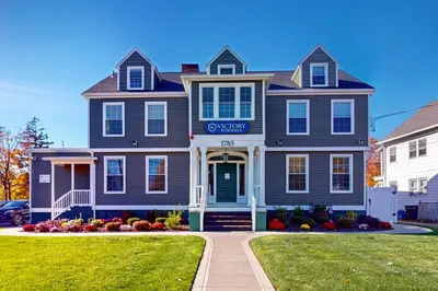 a blue house with a sign on the front of it at Centrally Located Home by Holyoke Medical Center in Holyoke