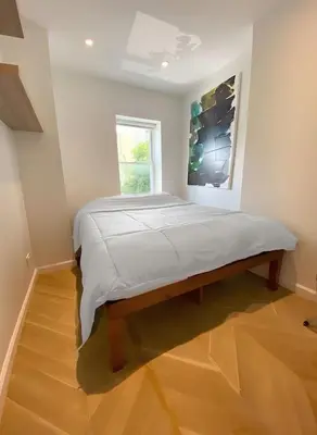 a large bed in a room with a window at Fully renovated 3 BDR Apt East Village in New York