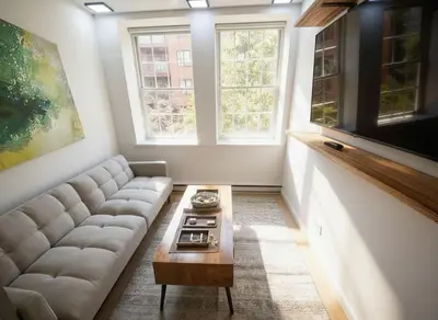 a living room with a couch and a coffee table at Fully renovated 3 BDR Apt East Village in New York