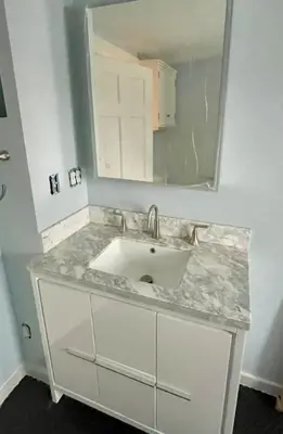 a bathroom counter with a sink and a mirror at Downtown 3BR duplex full kitchen parking off i-787 in Albany