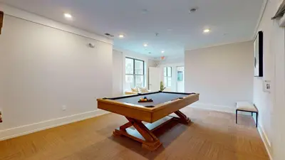 a room with a pool table in a room with a wall at Great Charming stay in Stamford