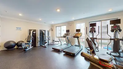 a gym with several treadmills and exercise machines at Great Charming stay in Stamford