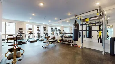 a gym with a bunch of equipment in a room at Cozy Modern Home Free Parking in Stamford