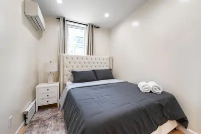 a bedroom with a large bed and a window at Spacious 3 Bed 3 Bath Unit in Upper East Side in New York