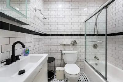 a bathroom with a toilet and a sink and a shower at Spacious 3 Bed 3 Bath Unit in Upper East Side in New York