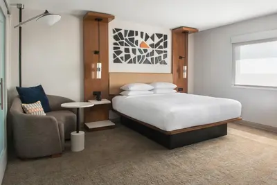 a bedroom with a bed and a chair at Marriott Springfield Downtown in Springfield