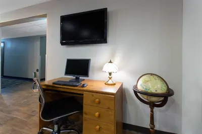 an office with a desk with a computer and a chair at Super 8 by Wyndham Cromwell/Middletown in Cromwell
