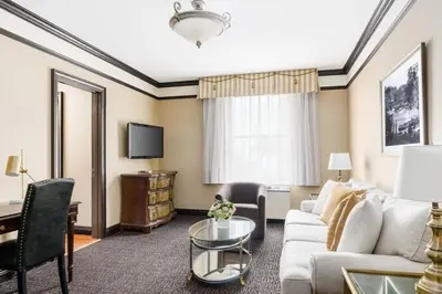 a living room with a couch and a table at Hotel Lucerne in New York