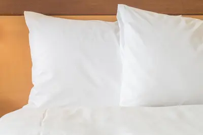 a stack of white pillows on a bed at Holiday Inn Budd Lake - Rockaway Area by IHG in Budd Lake